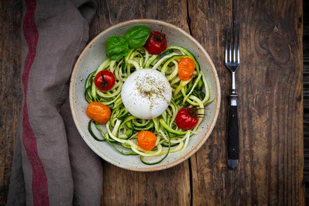 Bowl of zoodles with baked tomatoes and low carb burrata cheese  LVF08143