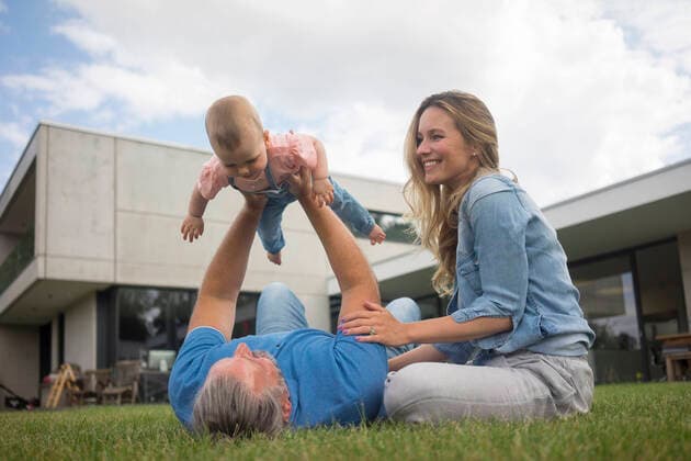 Happy father with mother lifting up baby girl in garden model released Symbolfoto property released  MOEF02426
