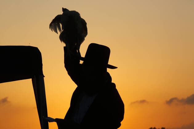 (191007) -- BEIT SHEMESH, Oct. 7, 2019 -- An Ultra-Orthodox Jewish man performs the Kaparot ritual, where white chickens are slaughtered as a symbolic gesture of atonement, ahead of Yom Kippur, the Jewish Day of Atonement, in Beit Shemesh, Israel, Oct. 6, 2019. (Photo by Gil Cohen Magen Xinhua) ISRAEL-BEIT SHEMESH-KAPAROT GuoxYu 