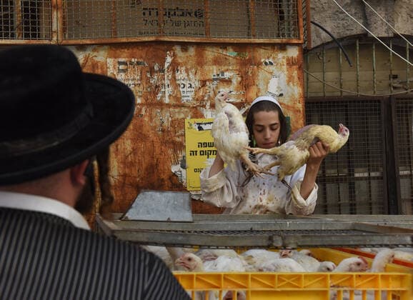 An Ultra-Orthodox Jewish youth holds chickens for the Kaparot ceremony in the Mea Shearim neighborhood, in Jerusalem, Monday, October 7, 2019. The Jewish ritual of Kaparot symbolically transfers the sin from the past year to the chicken and is performed before the Day of Atonement, Yom Kippur, the holiest day in the Jewish year. Yom Kippur begins at sunset on October 8, when Jews will refrain from eating, drinking, smoking, bathing, or having sex for nearly 26 hours.  JER2019100708 DEBBIExHILL
