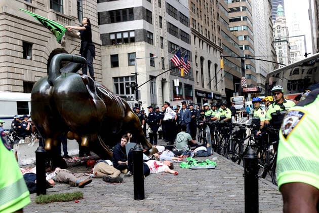 October 7, 2019, New York City, New York, US: Climate action group Extinction Rebellion launched a series of climate change protests around the globe on 7 October 2019, that featured large numbers of New York climate activists descending on lower Manhattan in actions that saw the iconic Charging Bull statute showered In Fake Blood and a die-in at the New York Stock Exchange on Wall Street, resulted in many arrests. New York City US - ZUMAl135 20191007_zap_l135_029 Copyright: xG.xRonaldxLopezx