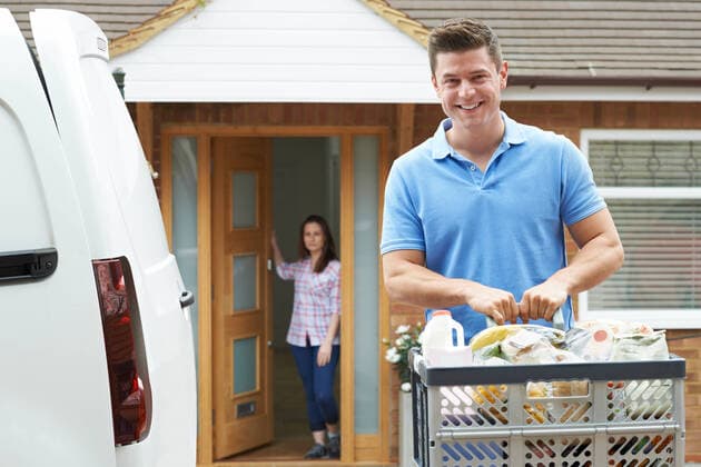 Portrait Of Driver Delivering Online Grocery Order To House,model released, Symbolfoto,property released INH_39524_06707