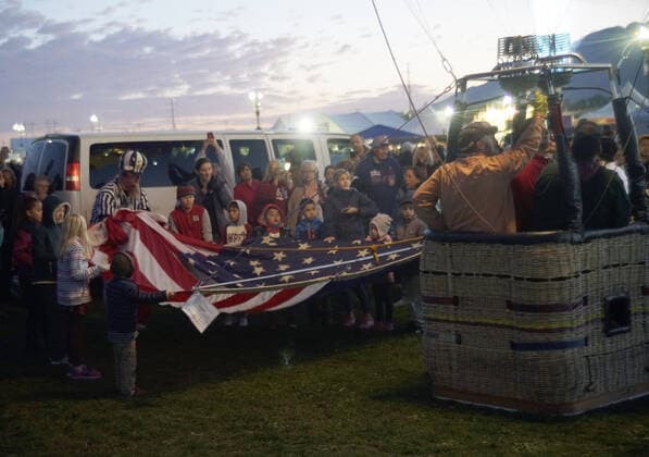 October 8, 2019, Albuquerque, NEW MEXICO, USA: 100819 .A group of youngsters hold the American Flag before the balloon carrying it takes off early Tuesday morning . Photographed on Tuesday October 8, 2019 . Journal Albuquerque USA - ZUMAab1_ 20191008_zaf_ab1_003 Copyright: xAdolphexPierre-Louisx