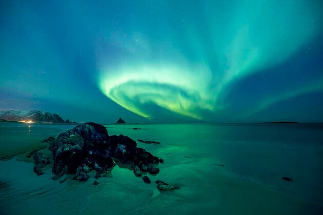 Northern lights showing above beach close to Bleiksoya bird island near Andenes, Andoya island, North Atlantic Ocean, Norway, January 2016  1538853 FrancoxBanfi