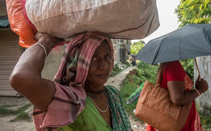 (191016) -- KOLKATA, Oct. 16, 2019 -- A woman carries heavy load on the International Day of Rural Women at Narayanpur village, some 45 km away from Kolkata, India on Oct. 15, 2019. The first International Day of Rural Women was observed on Oct. 15, 2008. The day, established by the UN General Assembly on Dec. 18, 2007, recognizes the critical role and contribution of rural women, including indigenous women, in enhancing agricultural and rural development, improving food security and eradicating rural poverty. Tumpa Mondal) INDIA-KOLKATA-INTERNATIONAL DAY OF RURAL WOMEN ZhangxNaijie 