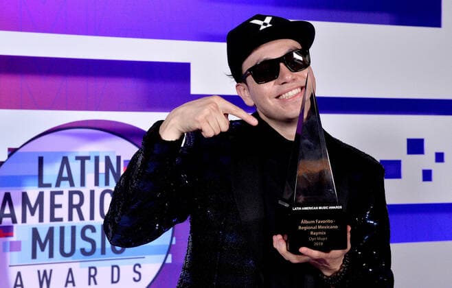 Singer Raymix appears backstage with his award for Favorite Album-Regional Mexican for Oye Mujer, during the fifth annual Latin American Music Awards at the Dolby Theatre in the Hollywood section of Los Angeles on Thursday, October 17, 2019. The annual event honors outstanding achievements for artists in the Latin music industry.  LAP20191017372 JIMxRUYMEN