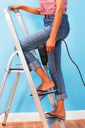 Woman Holding Power Drill on Stepladder,model released, Symbolfoto,property released 03B77802