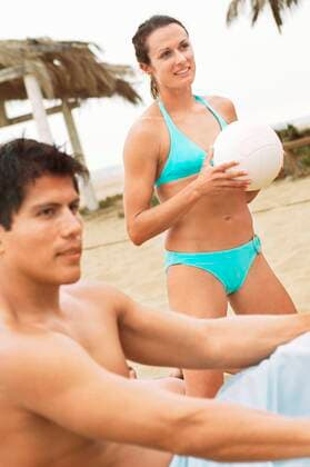 Woman in Bikini Holding Volleyball,model released, Symbolfoto 03B80200