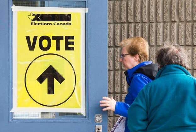 (191021) -- TORONTO, Oct. 21, 2019 -- People walk into a polling station in Toronto, Canada, Oct. 21, 2019. Canadians on Monday began voting in a general election after a 40-day campaign season. (Photo by Xinhua) CANADA-TORONTO-NATIONAL ELECTION ZouxZheng 