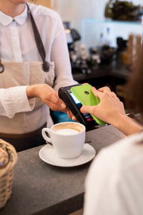 Close-up of customer paying cashless with smartphone in a cafe model released Symbolfoto property released  GIOF07083