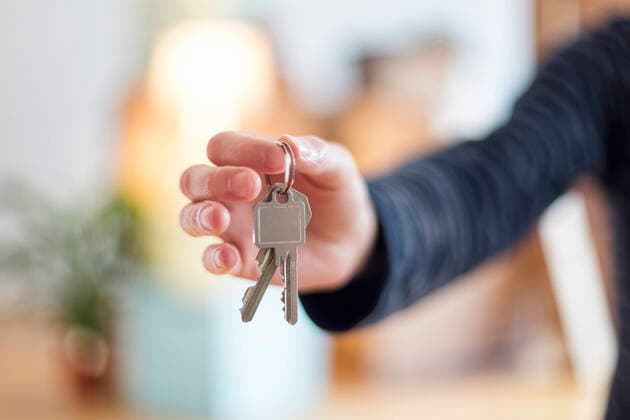 Close-up of man holding house key in new home model released Symbolfoto property released  MAMF00862