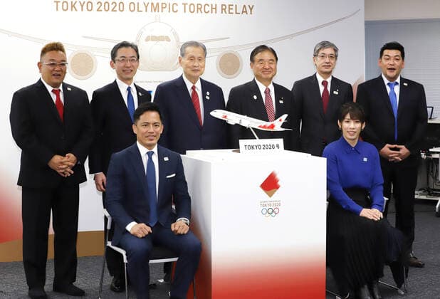 October 25, 2019, Tokyo, Japan - (Front L-R) Judo Olympic gold medalist Tadahiro Nomura and women s wrestling Olympic gold medalist Saori Yoshida (Back L-R) comedy duo Sandwitchman member Mikio Date, All Nippon Airways (ANA) president Yuji Hirako, Tokyo 2020 Olympics committee president Yoshiro Mori, former Olympic Minister Toshiaki Endo, Japan Airlines (JAL) president Yuji Akasaka and Sandwitchman member Takeshi Tomizawa pose for photo as they display the aircraft design to deliver Olympic flame from Greece in Tokyo on Friday, October 25, 2019. Nomura and Yoshida will carry Olympic flame back to Japan next March for Tokyo 2020 Olympics torch relay.  (115129886)