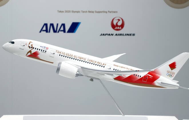 October 25, 2019, Tokyo, Japan - A model plane with a special design for the aircraft to deliver Olympic flame from Greece is displayed in Tokyo on Friday, October 25, 2019. Judo Olympic gold medalist Tadahiro Nomura and women s wrestling gold medalist Saori Yoshida will carry Olympic flame back to Japan next March for Tokyo 2020 Olympics torch relay.  (115129902)