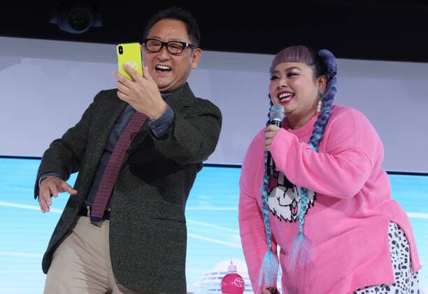 October 26, 2019, Tokyo, Japan - Toyota Motor president Akio Toyoda (L) and TV personality Naomi Watanabe (R) take a selfie aftr they hold a talk show at the Toyota booth at the Tokyo Motor Show in Tokyo on Saturday, October 26, 2019. Toyota displayed future mobilities and robots at the show.  (115176926)