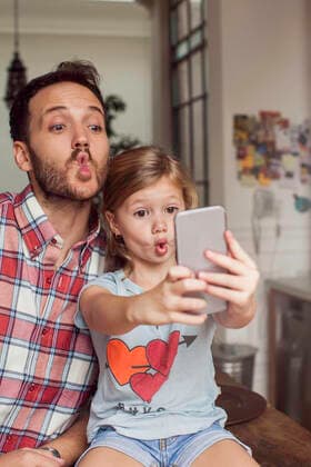 Father posing for selfie with daughter  Copyright: SigridxOlsson B83391022