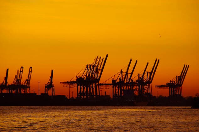 Feature export and import, German economy container gantry cranes in Hamburg port at sunset