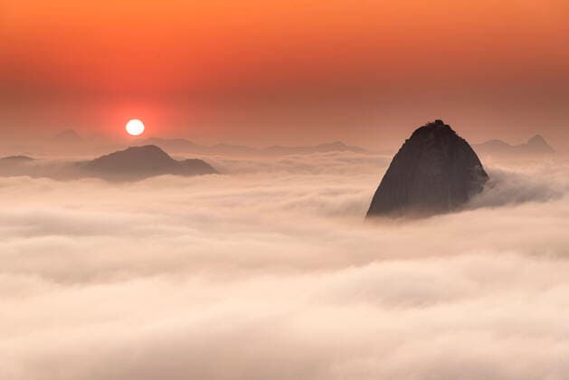 Beautiful landscape of sunrise and mountain rising above low clouds Brazil, State of Rio de Janeiro, Rio de Janeiro CR_GNUJ191008A-209387-01
