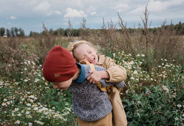 brother carrying his sister laughing through a wild flower field Sweden, Stockholm County, Norrtälje CR_RABE191001A-200331-01