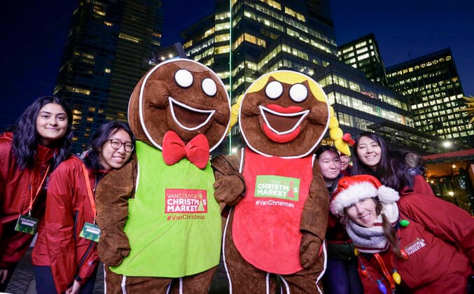 (191120) -- VANCOUVER, Nov. 20, 2019 (Xinhua) -- People pose for photos with gingerbread mascots at the Vancouver Christmas Market at Jack Poole Plaza in Vancouver, Canada, Nov. 19, 2019. The Vancouver Christmas Market celebrates its 10th anniversary that features more than 80 huts stuffed with food, treats together with different festive activities for locals and visitors to enjoy. (Photo by Liang Sen Xinhua) CANADA-VANCOUVER-CHRISTMAS MARKET 