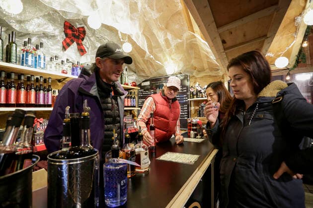 (191120) -- VANCOUVER, Nov. 20, 2019 (Xinhua) -- A woman tastes wine in a hut at the 10th annual Vancouver Christmas Market at Jack Poole Plaza in Vancouver, Canada, Nov. 19, 2019. The Vancouver Christmas Market celebrates its 10th anniversary that features more than 80 huts stuffed with food, treats together with different festive activities for locals and visitors to enjoy. (Photo by Liang Sen Xinhua) CANADA-VANCOUVER-CHRISTMAS MARKET 