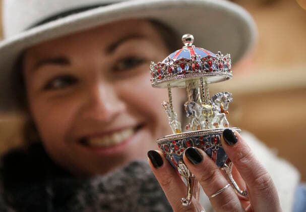 (191120) -- VANCOUVER, Nov. 20, 2019 (Xinhua) -- A store vendor displays a merry-go-round music box at the Vancouver Christmas Market at Jack Poole Plaza in Vancouver, Canada, Nov. 19, 2019. The Vancouver Christmas Market celebrates its 10th anniversary that features more than 80 huts stuffed with food, treats together with different festive activities for locals and visitors to enjoy. (Photo by Liang Sen Xinhua) CANADA-VANCOUVER-CHRISTMAS MARKET 