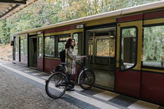 Woman with bicycle entering an underground train, Berlin, Germany model released Symbolfoto  AHSF01240