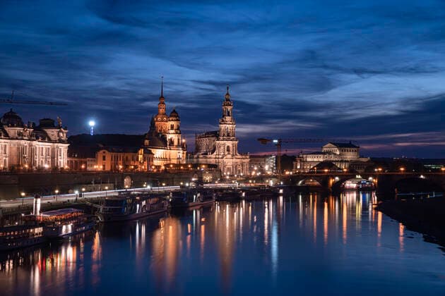 Elbe river by Hofkirche und Semperoper against sky in city at night, Saxony, Germany  CHPF00563