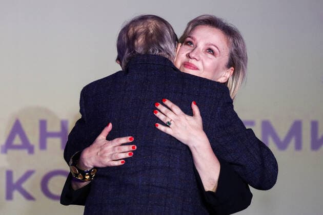 MOSCOW, RUSSIA - NOVEMBER 25, 2019: Dmitry Brusnikin s widow Marina Brusnikina (R) accepts a Stanislavsky Award in the Drama Teaching category on behalf of her late husband, theatre director Dmitry Brusnikin, at the 24th Stanislavsky award ceremony at the Baltschug Keminski Hotel. Sergei Bobylev TASS  TS0C4A95