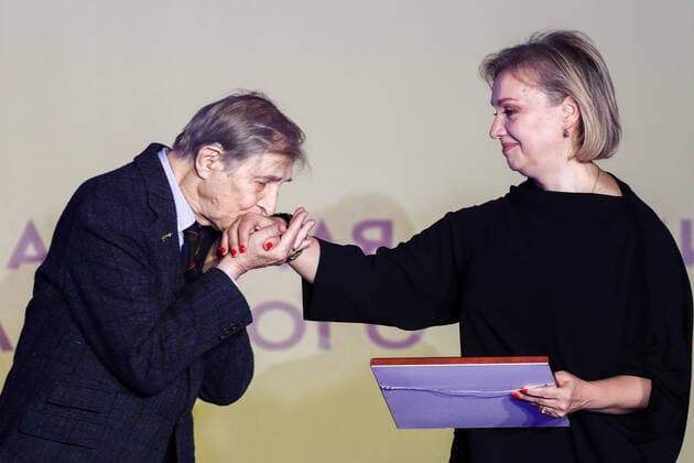 MOSCOW, RUSSIA - NOVEMBER 25, 2019: Dmitry Brusnikin s widow Marina Brusnikina (R) accepts a Stanislavsky Award in the Drama Teaching category on behalf of her late husband, theatre director Dmitry Brusnikin, from actor Igor Yasulovich at the 24th Stanislavsky award ceremony at the Baltschug Keminski Hotel. Sergei Bobylev TASS  TS0C4A98