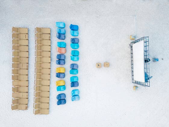 Drone shot of chairs with projection screen arranged at Gili-Air Island in Bali, Indonesia  KNTF03470