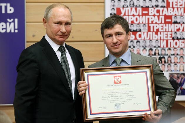 ST PETERSBURG, RUSSIA - NOVEMBER 27, 2019: Russia s President Vladimir Putin (L) and coach Yevgeny Stanev of Olympic Reserve School 1, who has received a certificate of merit, during a ceremony to present state awards at the Turbostroitel judo club. Mikhail Tereshchenko TASS  TS0C506B