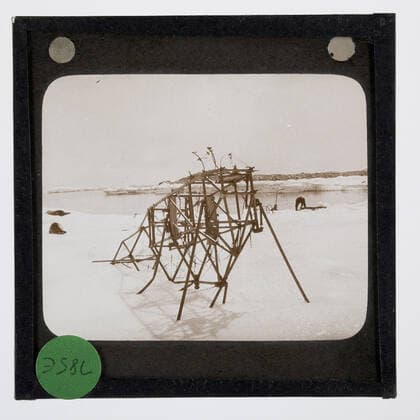 Lantern Slide - Abandoned Airframe, Cape Denison, BANZARE Voyage 2, Antarctica, Jan 1931, Lantern slide of an aircraft frame from the Australasian Antarctic Expedition AAE of 1911-1914. It was used as an air tractor on the snow around Mawson s Huts. It was considered to be a cumbersome machine and it was stripped of its engine. One of 328 images in various formats including artworks, photographs, glass negatives and lantern slides.  Copyright Artokoloro LC190917_104939