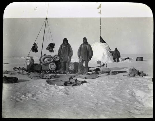 Lantern Slide - British Imperial Antarctic Expedition, Adams, Wild, Shackleton at Campsite, Antarctica, Jan 1909, Photograph depicting members of the British Imperial Antarctic Expedition, Jameson Adams, Frank Wild and Ernest Shackleton, at a supply depot in Antarctica on January 1909. The image was taken by Eric Marshall on their return journey from their farthest south position of 88Âº23 S.  Copyright Artokoloro LC190917_105067