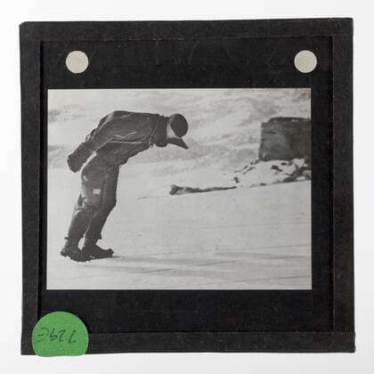 Lantern Slide - Explorer Leaning on the Wind, Australasian Antarctic Expedition (AAE), Antarctica, 1911-1914, Monochrome lantern of an explorer in Antarctica. One of 328 images in various formats including artworks, photographs, glass negatives and lantern slides.  Copyright Artokoloro LC190917_105291