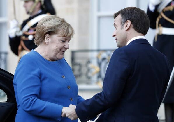 PARIS, FRANCE â€“ DECEMBER 9, 2019: Germany s Chancellor Angela Merkel (L), and France s President Emmanuel Macron at the Elysee Palace before a Normandy Four summit; talks in the so-called Normandy Four format involve representatives of Ukraine, Germany, France and Russia who discuss settlement of the conflict in eastern Ukraine. Grigory Dukor TASS  TS0C6B20