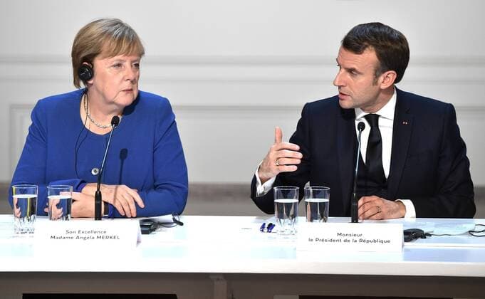 December 10, 2019. - France, Paris. - Germany s Chancellor Angela Merkel (left) and France s President Emmanuel Macron give a news conference after a Normandy Four summit at the Elysee Palace. KremlinxPool 