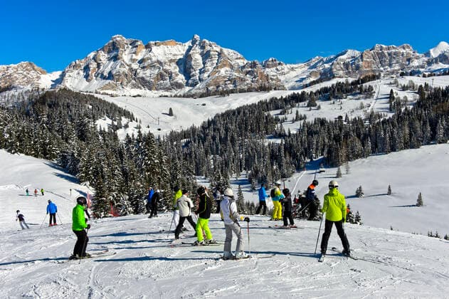 Skiers on a ski slope in the ski resort Alta BadiaDolomites, South Tyrol, Italy