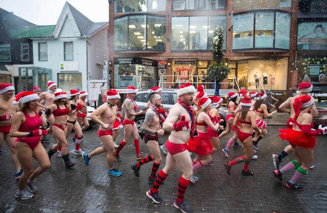 (191214) -- TORONTO, Dec. 14, 2019 -- Participants take part in the 2019 Toronto Santa Speedo Run in Toronto, Canada, Dec. 14, 2019. Dozens of participants dressed in bathing suits and Santa Claus hats took part in this annual event on Saturday to raise money for sick kids. (Photo by Xinhua) CANADA-TORONTO-SANTA SPEEDO RUN ZouxZheng 