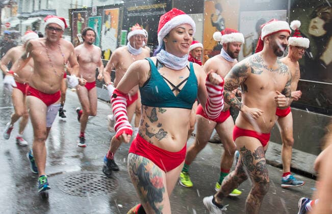 (191214) -- TORONTO, Dec. 14, 2019 -- Participants take part in the 2019 Toronto Santa Speedo Run in Toronto, Canada, Dec. 14, 2019. Dozens of participants dressed in bathing suits and Santa Claus hats took part in this annual event on Saturday to raise money for sick kids. (Photo by Xinhua) CANADA-TORONTO-SANTA SPEEDO RUN ZouxZheng 