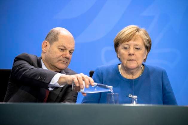 L R Federal Minister of Finance Olaf Scholz and Federal Chancellor Angela Merkel at the end of a press conference after the signing of a declaration of intent by representatives of the Federal Government and the participating associations and institutions on the immigration of experts in the Chancellery in Berlin on 16 December 2019