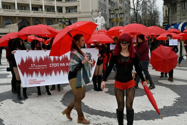 Prostitute protest - Skopje, Macedonia 17.12.2019., Skopje, Macedonia - Annual Mars of the Red Umbrellas held to promote the rights of sex workers in Macedonia. Girls with masks and red umbrellas marched and demand from state bodies to remove prejudice and condemnation and prevent violence against sex workers.  STR-1234 HaloPix PIXSELL