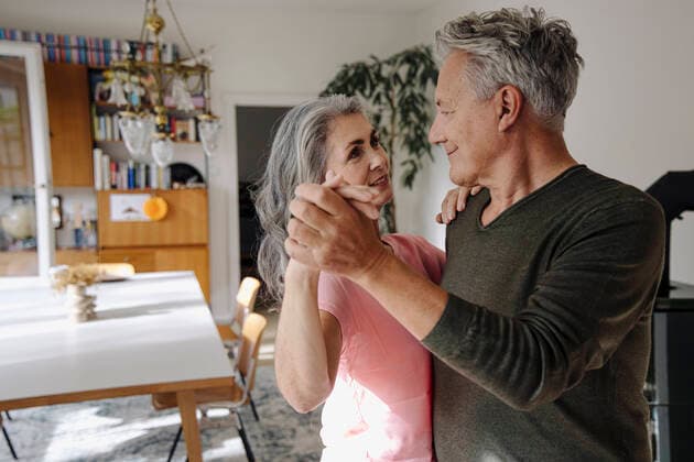 Senior couple dancing in living room at home model released Symbolfoto property released  GUSF03116