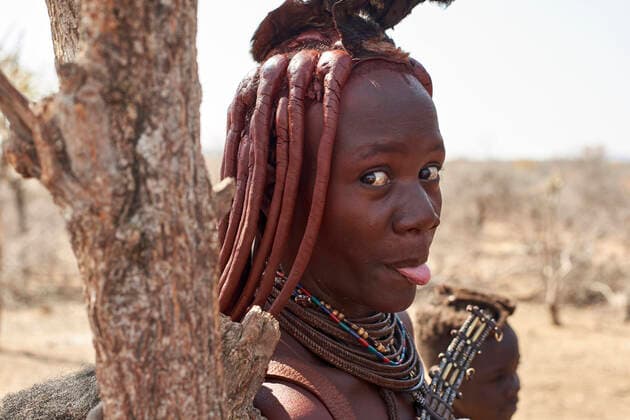 Creative Highlights Symbolfotos Portrait of a Himba woman sticking out tongue, Opuwo, Namibia model released Symbolfoto  VEGF00913
