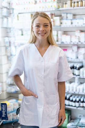 Young woman wearing laboratory coat standing in pharmacy Copyright: FrédéricxCirou B61596239