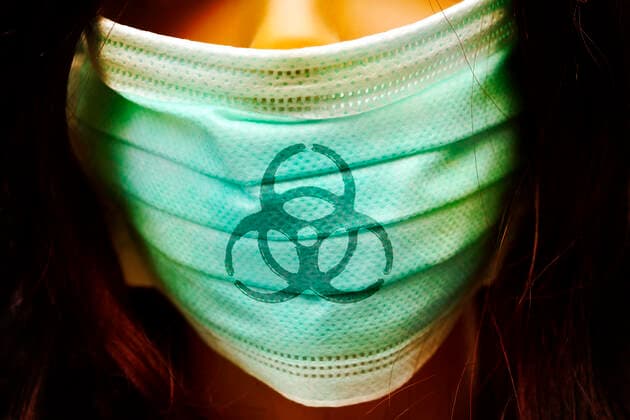 PHOTOMONTAGE, woman with mouthguard and biohazard sign, symbol photo coronavirus ** NUR FUER REDAKTIONELLE ZWECKE ** EDITORIAL USE ONLY **