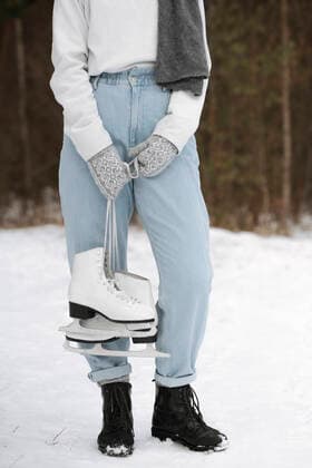 IMAGO Creative, Jahreszeit Winter, Eislaufen Crop view of woman with ice skates in winter model released Symbolfoto  EYAF00810