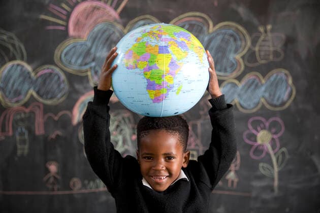 School boy holding a globe on his head  Copyright: xGreatstockx O-066-0592G