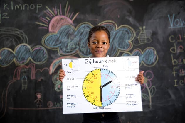 School girl holding a clock  Copyright: xGreatstockx O-066-0593G