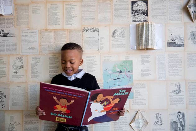 School boy reading in the classroom  Copyright: xGreatstockx O-066-0597G