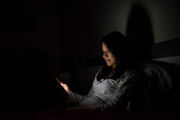 Latino woman using her cell phone before bed Madrid, Community of Madrid, Spain CR_DAES200110B-281511-01